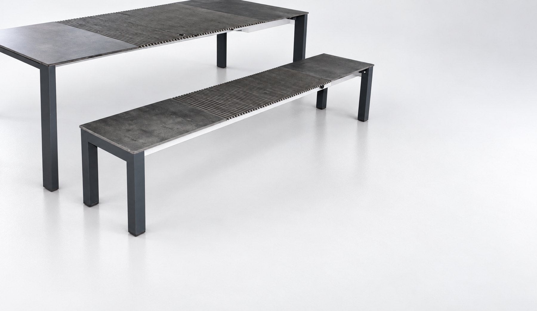 The outdoor bench beside the table