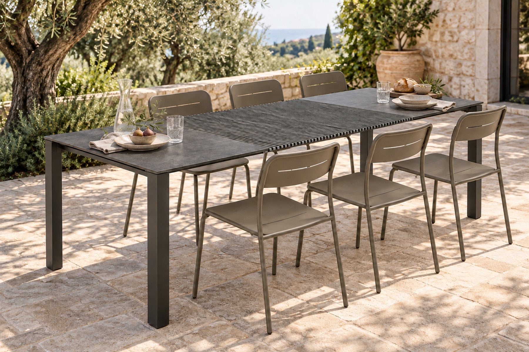 Nero chairs in Beige Grey around the Accordion Table Outdoor on a terrace
