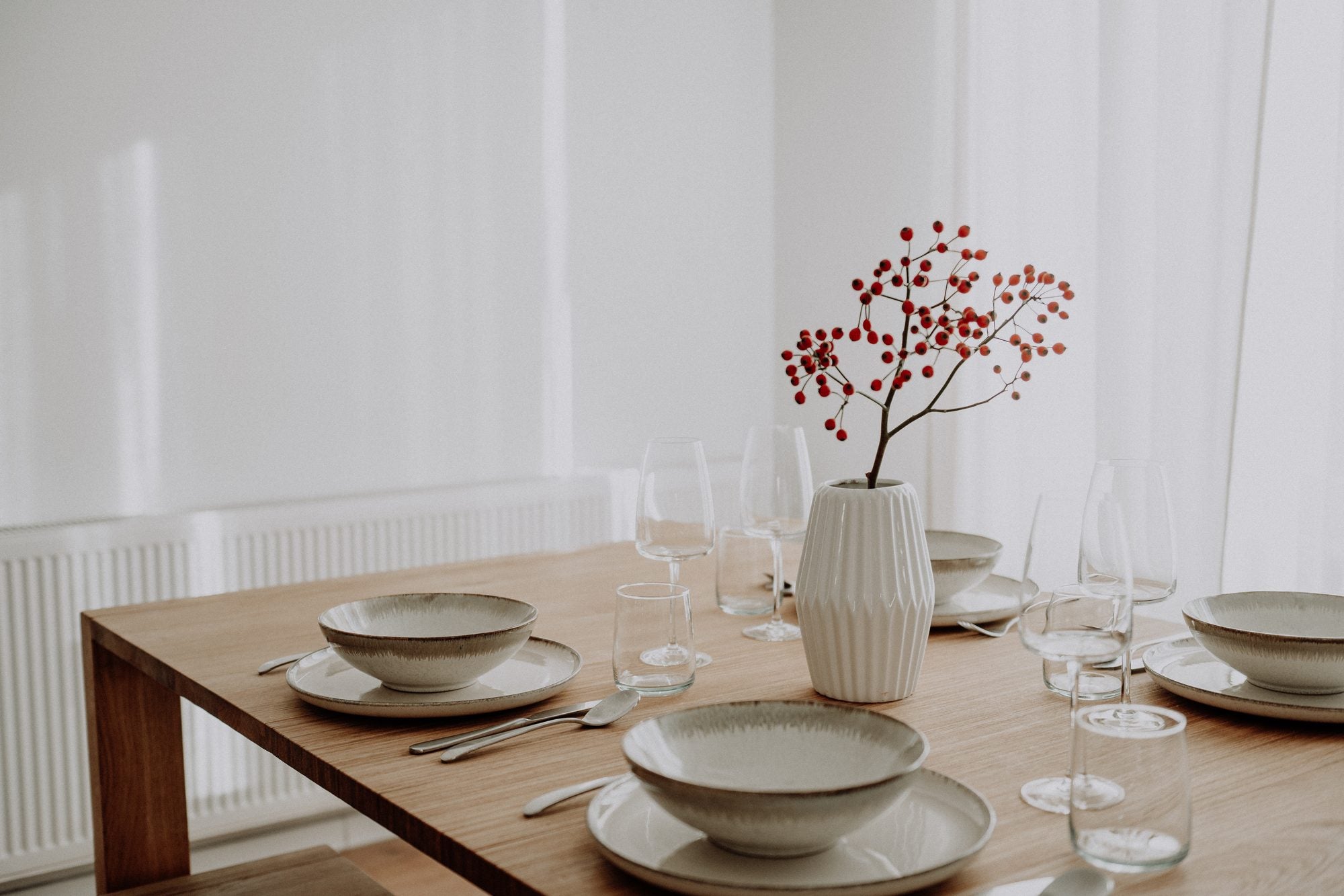 The oak Accordion Table set for a holiday meal by a bright window