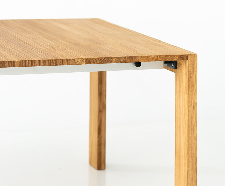 Wooden table with an extension mechanism