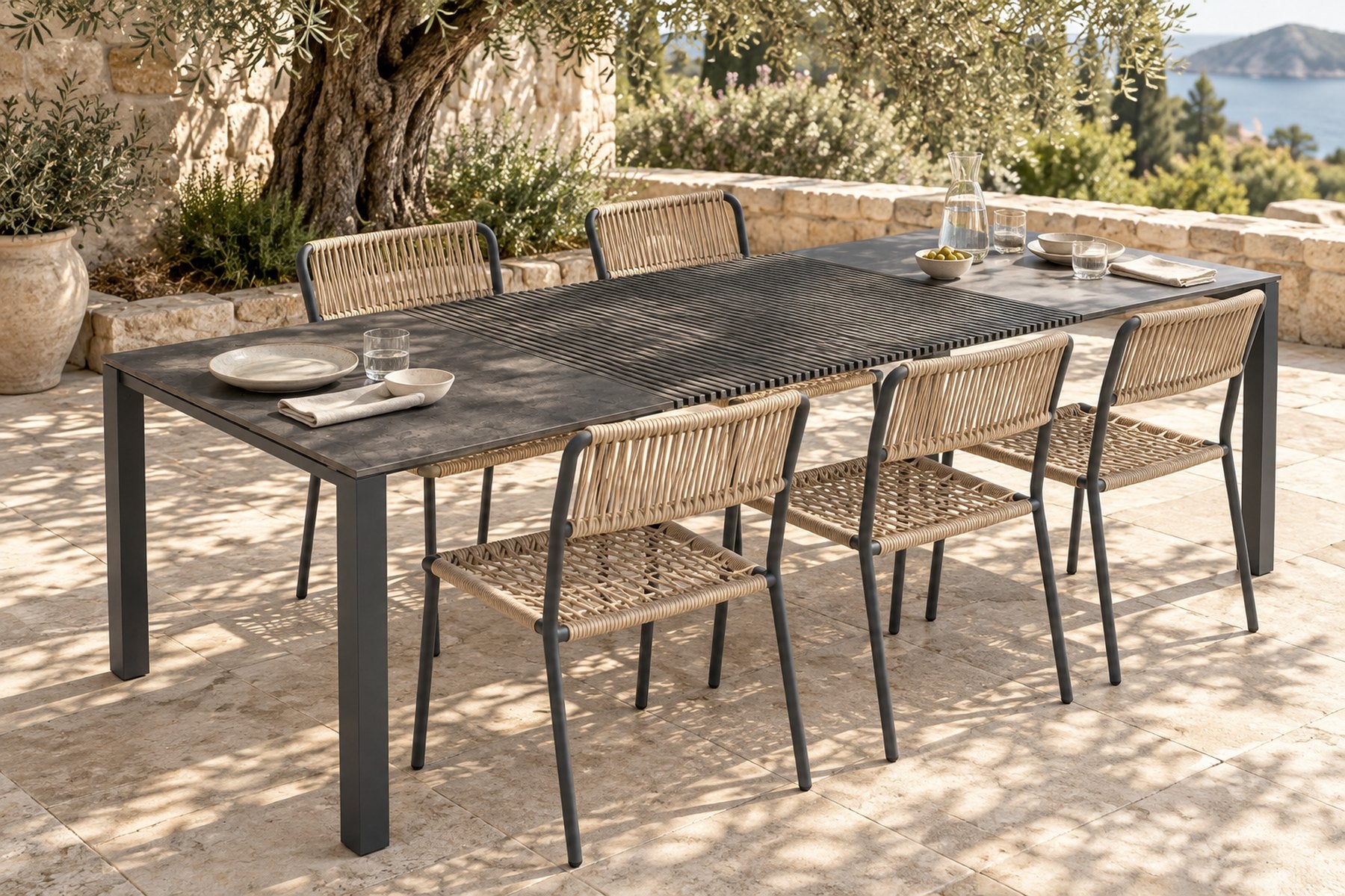 Bianca chairs in Anthracite Grey around the Accordion Table Outdoor on a terrace