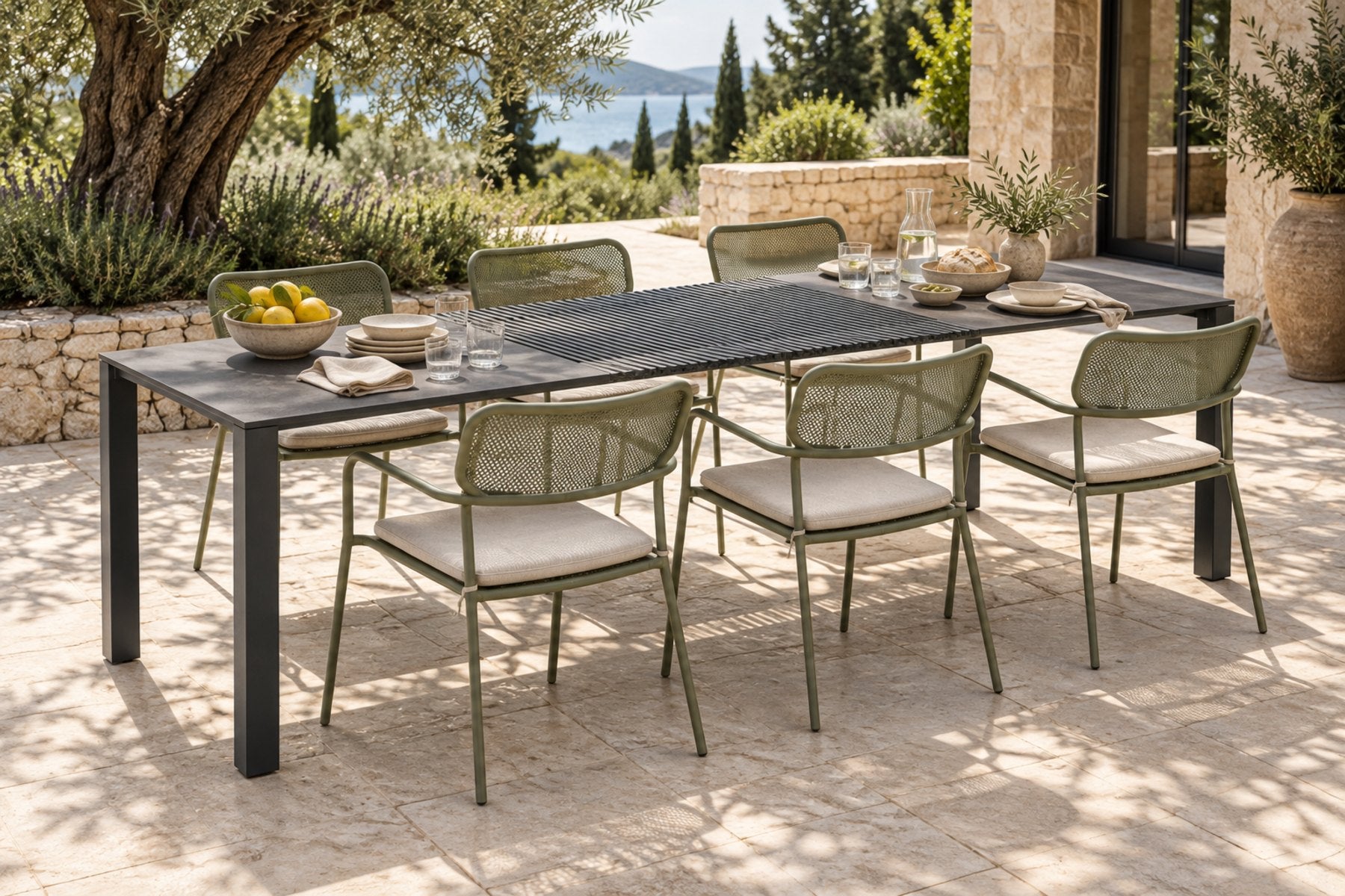 Totem chairs in Reed Green around the Accordion Table Outdoor on a terrace
