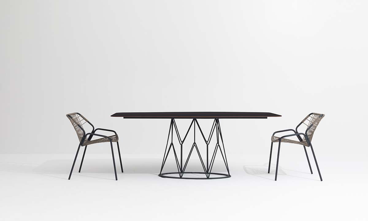 Two Kapua chairs at a round table
