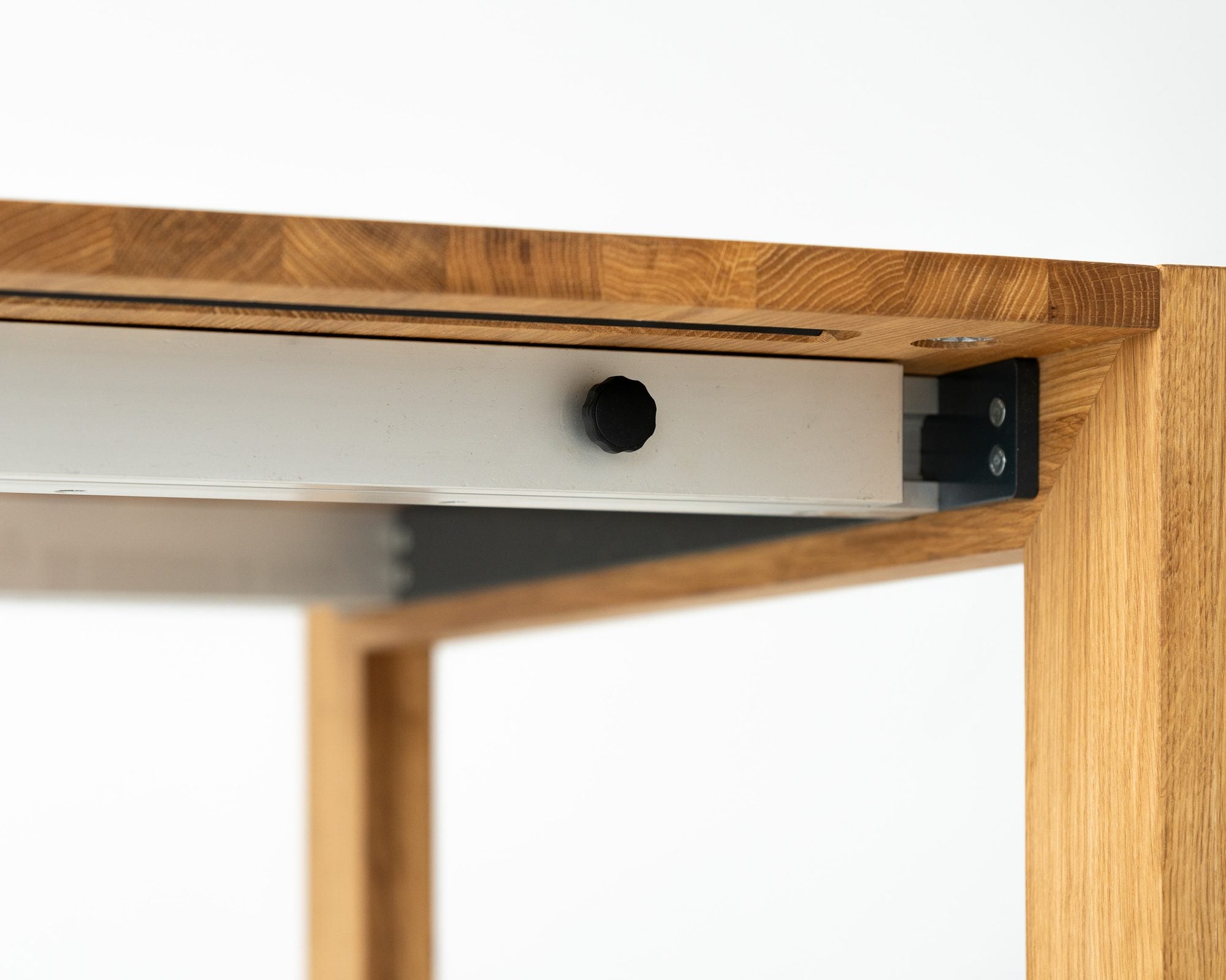The aluminum rail and the wheel under the top