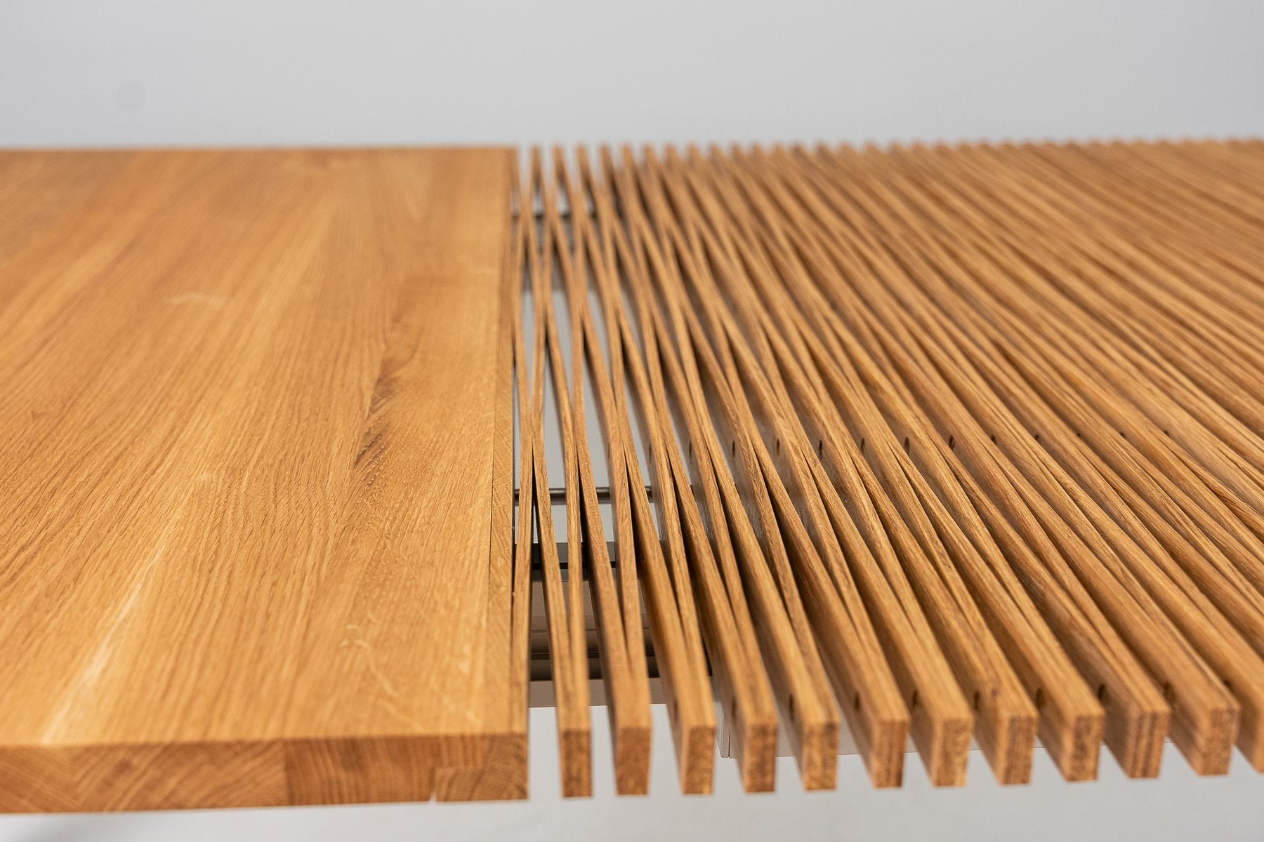 A solid oak end beside the open lamellas, in the studio