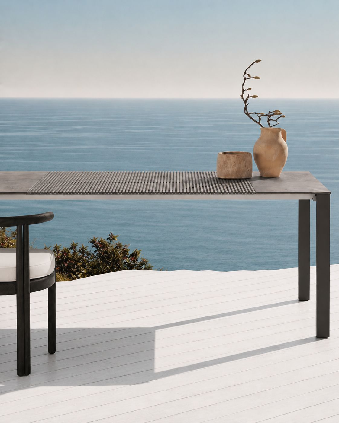 The outdoor Accordion Table on a terrace above the sea